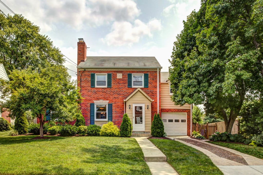 red brick home on sunny day green grass