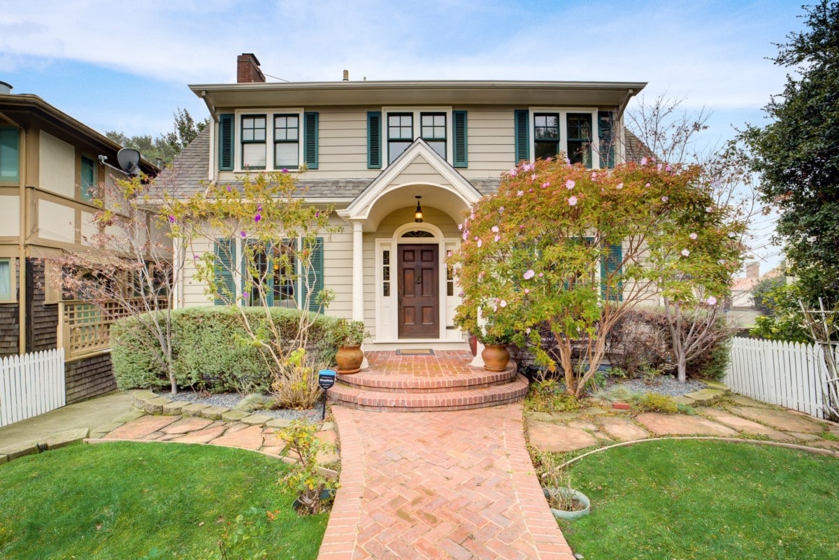 A photo of a two story home standing out with green shutters and great curb appeal on virtual house tour