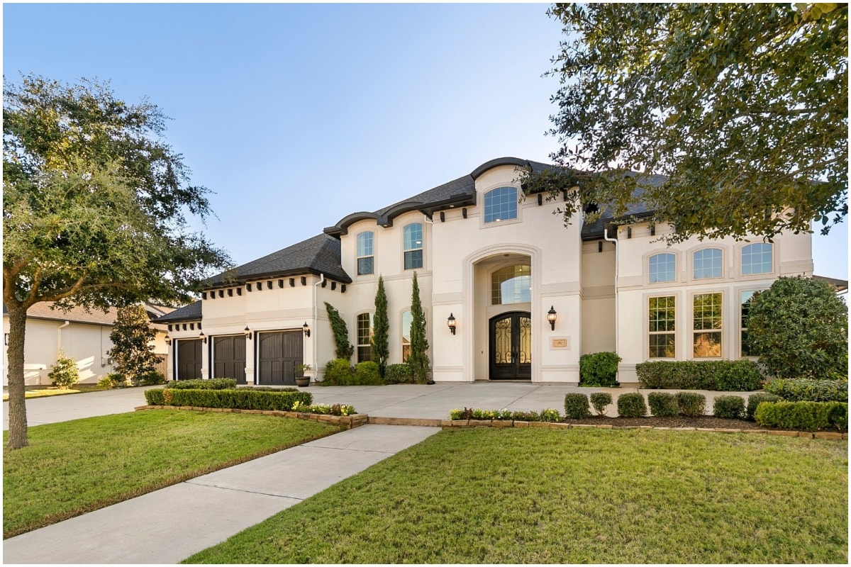 white and black modern mansion manicured lawn