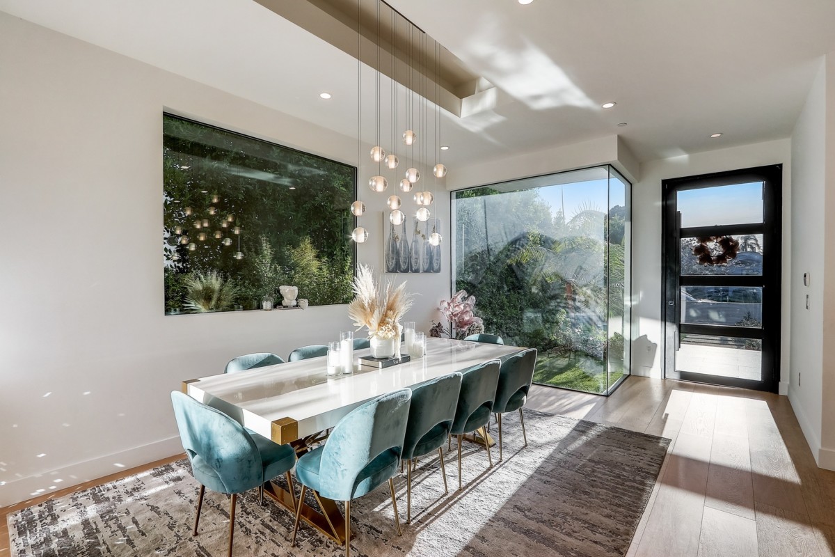 dining room with glass walls and plants behind them