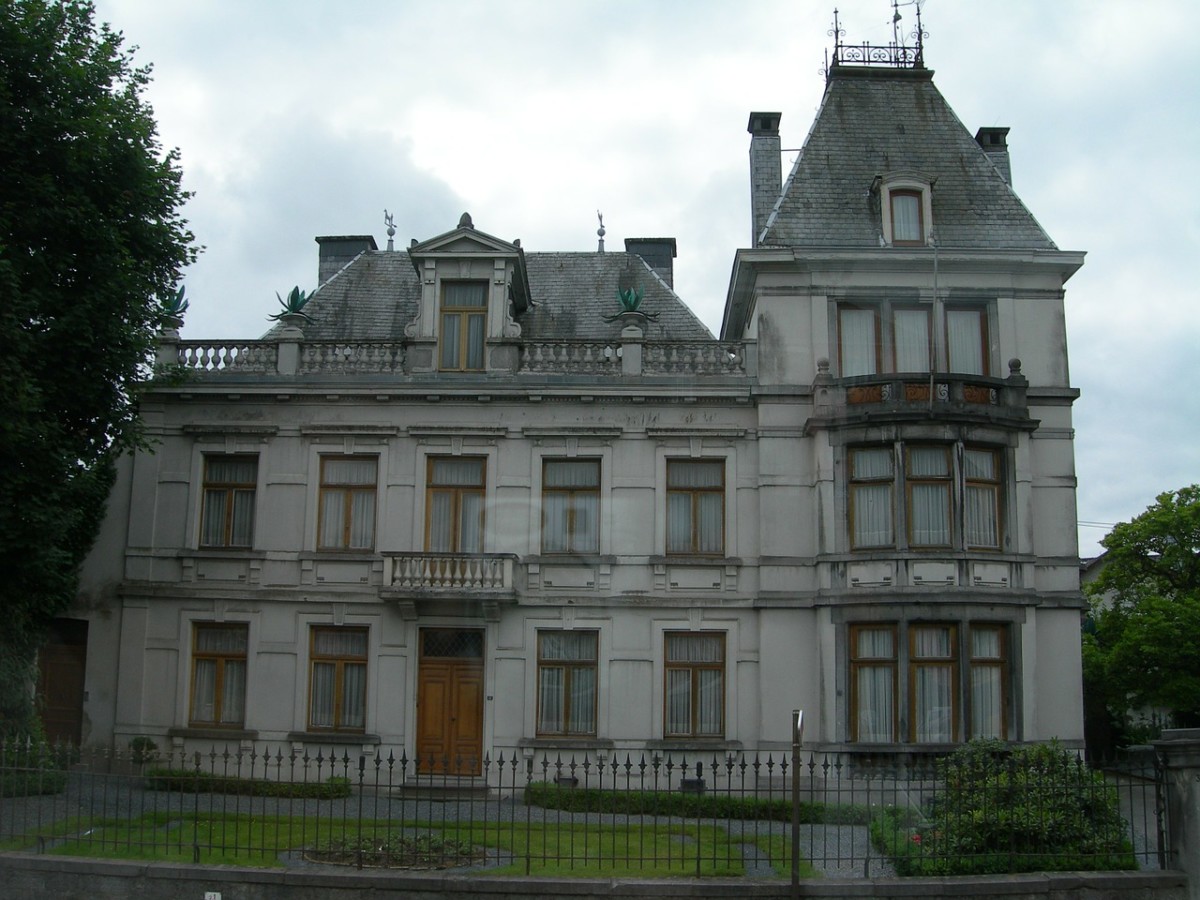 second empire victorian style home with many windows and elaborate exterior