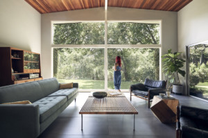 woman standing in living room pondering on how to get a home loan