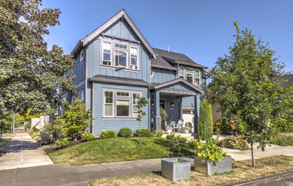 Blue two-story home with a small front yard