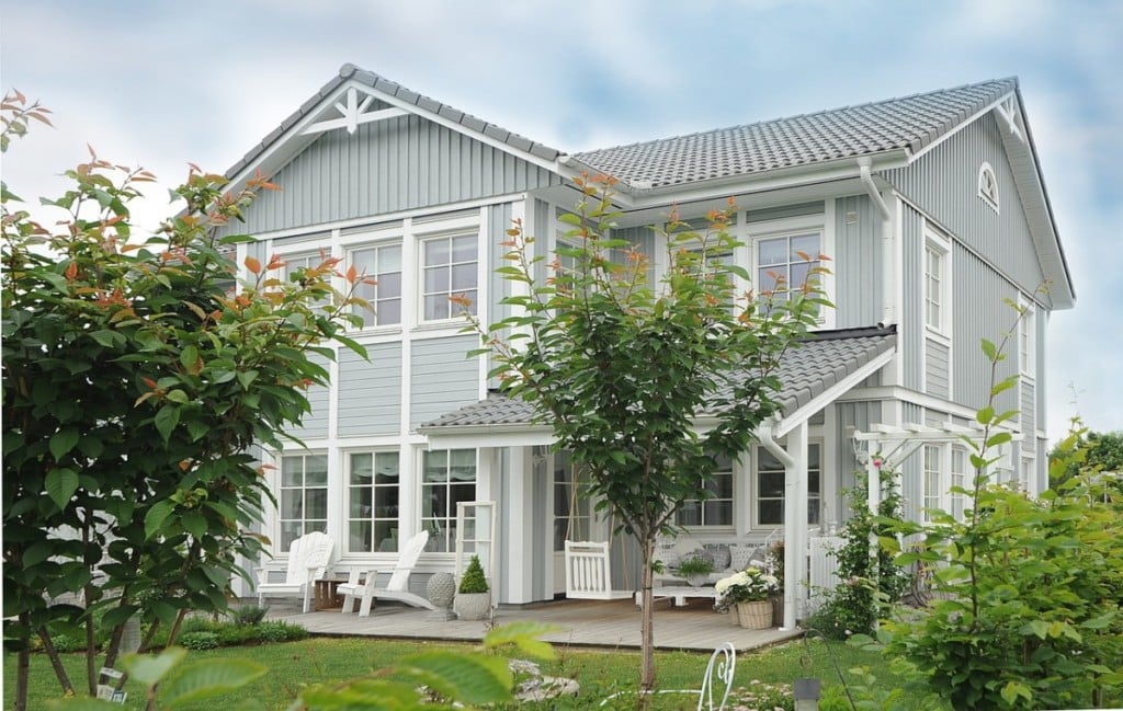 Blue, two-story home with a water well system